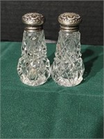 Antique cut glass S&P's. Sterling silver tops