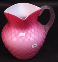 An 8" pink quilted satin glass cased pitcher,