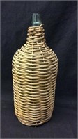 Early Glass Jug Wrapped On Wicker