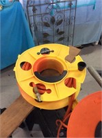 Orange air hose on yellow reel