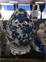 Blue and white egg on pedestal