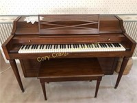 Baldwin spinet piano with bench and sheet music...