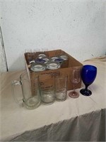 Group of drinking glasses includes dark blue wine