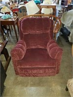 Burgundy rocker recliner. Reclones well. Has some