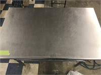 Stainless steel table with full lower shelf.