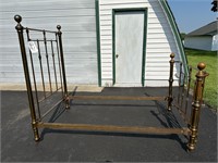 Full size brass bed on casters