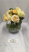 Fake yellow roses in glass bowl vase