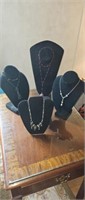 4 costume necklaces with out stands