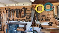 Contents of pegboard wall. Clamps wrenches