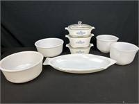 Three covered corning wear casserole dishes with