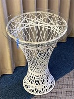 White wicker table with round glass top.