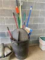Trash can with brooms & mops