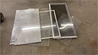 Four sheets of plexi glass, window screen, and