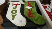 ^ 2 Christmas stockings “Joy” and “Peace”.