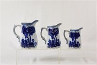 Flow Blue Three Creamer Jugs with Gold Highlights
