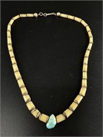 Necklace made from carved nuts and a turquoise spe
