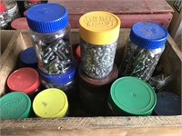 Box full of jars, fill of nuts and bolts.