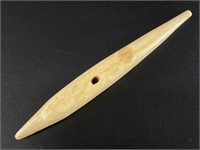 This ivory artifact is likely a snowshoe needle. 6