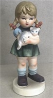 Figurine girl holding a cat
