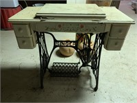 Old Singer sewing machine in painted wood cabinet