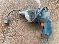 Black & Decker  electric drill, plugged in and