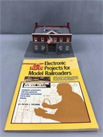 Model railroad idea book and plastic police