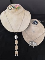 Three beautiful brooches and two necklaces