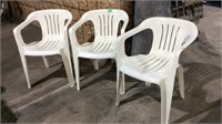 Three plastic stackable chairs