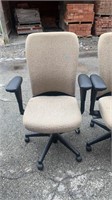 2 tan office chairs on rollers