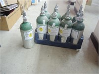 9 OXYGEN TANKS APPOX 1 FT TALL BELIEVE TO BE FULL