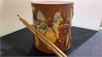Native American drum with pair of drumsticks.