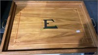 Inlaid wood serving tray with “E” monogram.