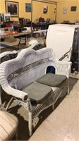 White wicker love seat with two chair cushions 50
