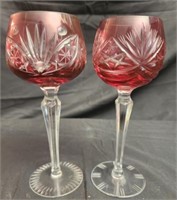 2 pink colored crystal glasses