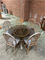 Glass Top and Cane outdoor Table and Chairs.