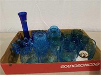 A large assortment of blue glassware various