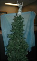 christmas tree with skirt, ornaments, and topper