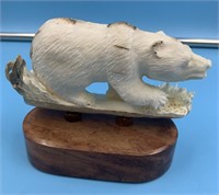 Relief fossilized walrus ivory carving of a bear b