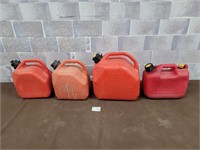 Gas cans, one full, one part jug mixed fuel