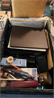 Assorted office supplies in crate