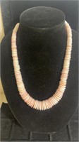 Mid length pale pink stacked disc necklace