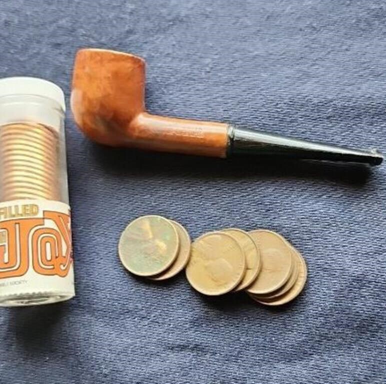 Wheat pennies a briar pipe and 1984 pennies