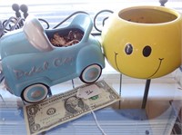 Vintage toy pedal car and smiley face pot