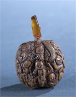 Chinese carved walnut snuff bottles.