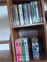 2 shelves of assorted DVDs and VHS tapes