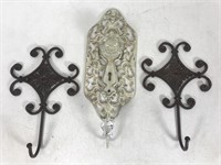 Three ornate metal wall hangers