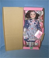 Porcelain doll with fancy dress and hat