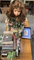 One porcelain collector doll in a green plaid