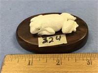 2 1/2" ivory carving of a frog, mounted on a wood