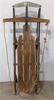 Vintage wood sled with metal runners. Marked